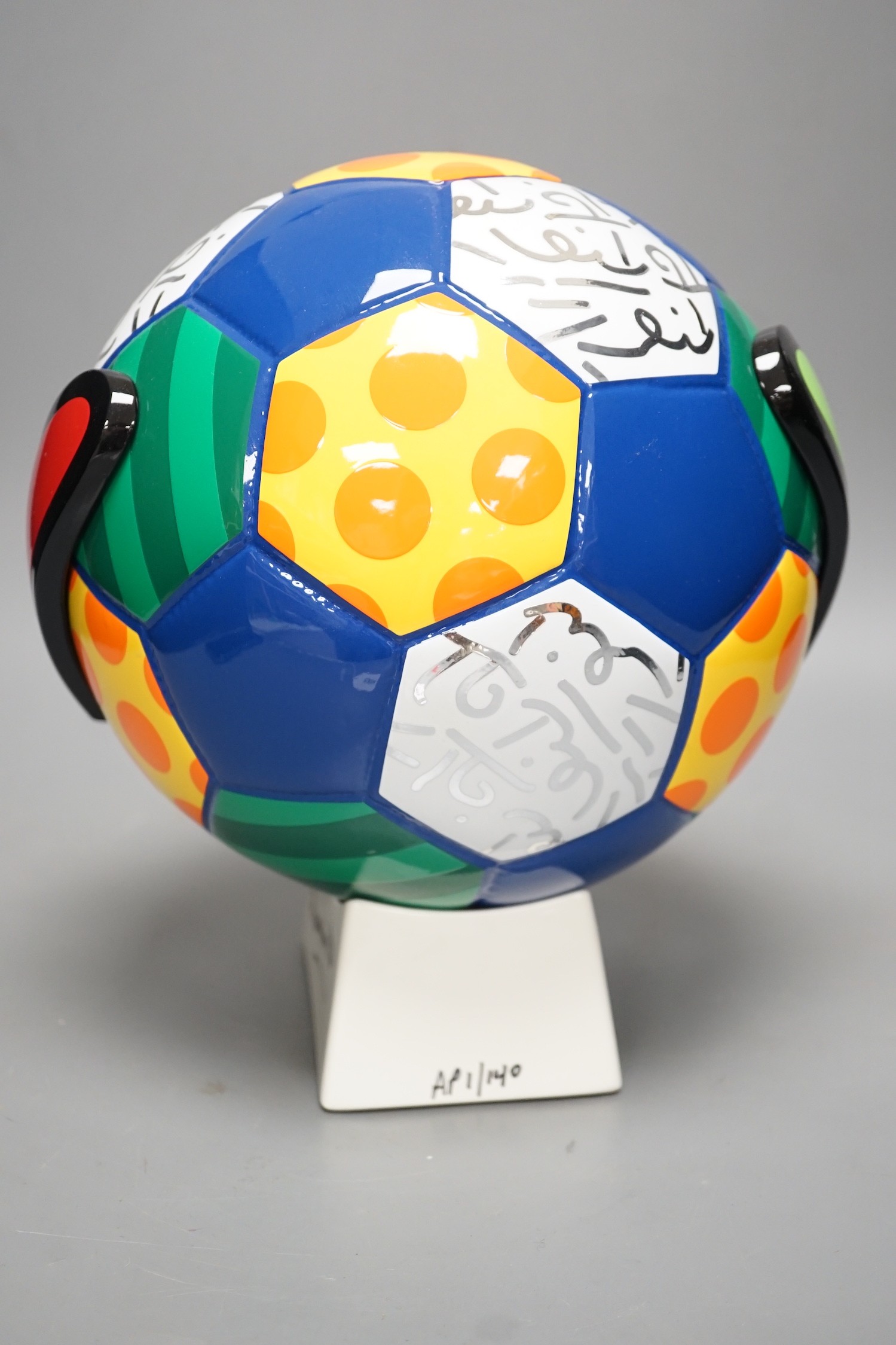 Romero Britto (Brazilian, 1963-), a ceramic football, 26cm